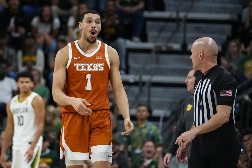Texas's Dylan Disu (1) reacts after being called for a technical foul after scoring a three-point basket against Baylor during the first half of an NCAA college basketball game, Monday, March 4, 2024, in Waco, Texas. (AP Photo/Julio Cortez)