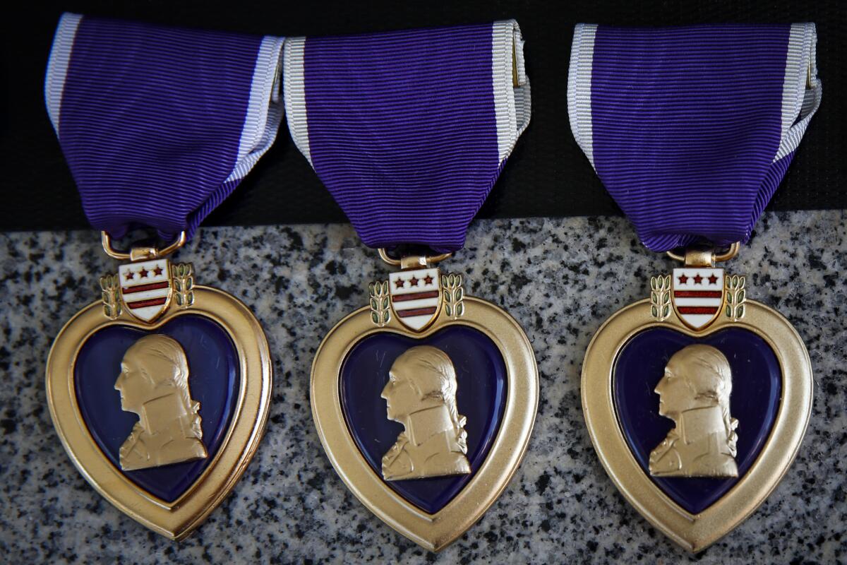 Purple hearts rest on a memorial to honor the 34 Marines and a Navy Hospital Corpsman killed in the Battle of Ramadi, Iraq on 10th anniversary of the battle at a ceremony in the San Mateo Memorial Garden at US Marine Corps Base Camp Pendleton on Sunday, April 6, 2014 in Camp Pendleton, Calif.
