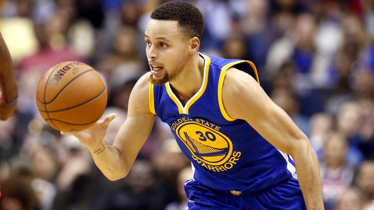 Warriors guard Stephen Curry brings the ball up court during a game against the Wizards on Feb. 3.