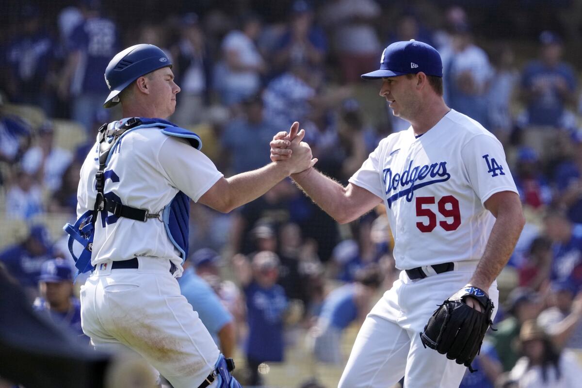 Dodgers catcher Will Smith, left, and relief pitcher Evan Phillips celebrate.