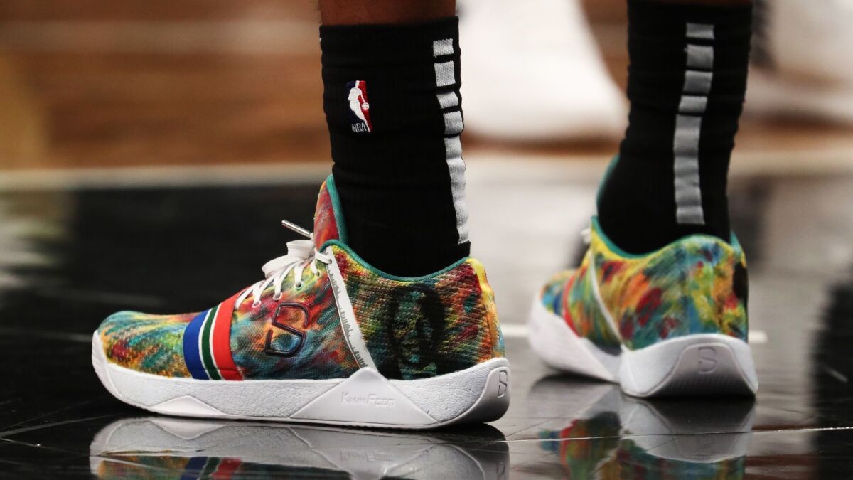 Spencer Dinwiddie's sneakers pay tribute to Nelson Mandela during the Brooklyn Nets game against the Utah Jazz at the Barclays Center in New York on Nov. 28.