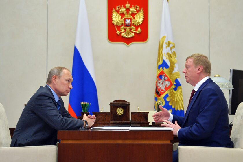 FILE - Russian President Vladimir Putin, left, listens to RUSNANO CEO Anatoly Chubais in the Novo-Ogaryovo residence, outside Moscow, Russia, Monday, Nov. 7, 2016. The resignation of Chubais, who was Putin's envoy to international organizations for sustainable development, was not the first resignation of a state official over the war with Ukraine, but it was one of the most striking. (AP Photo)