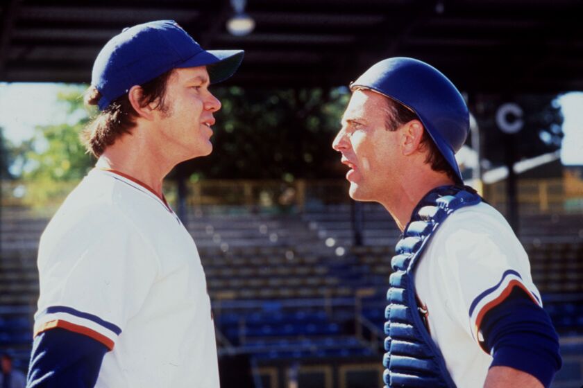 Tim Robbins, left, and Kevin Costner in a scene from "Bull Durham" in 1988, written and directed by Ron Shelton.