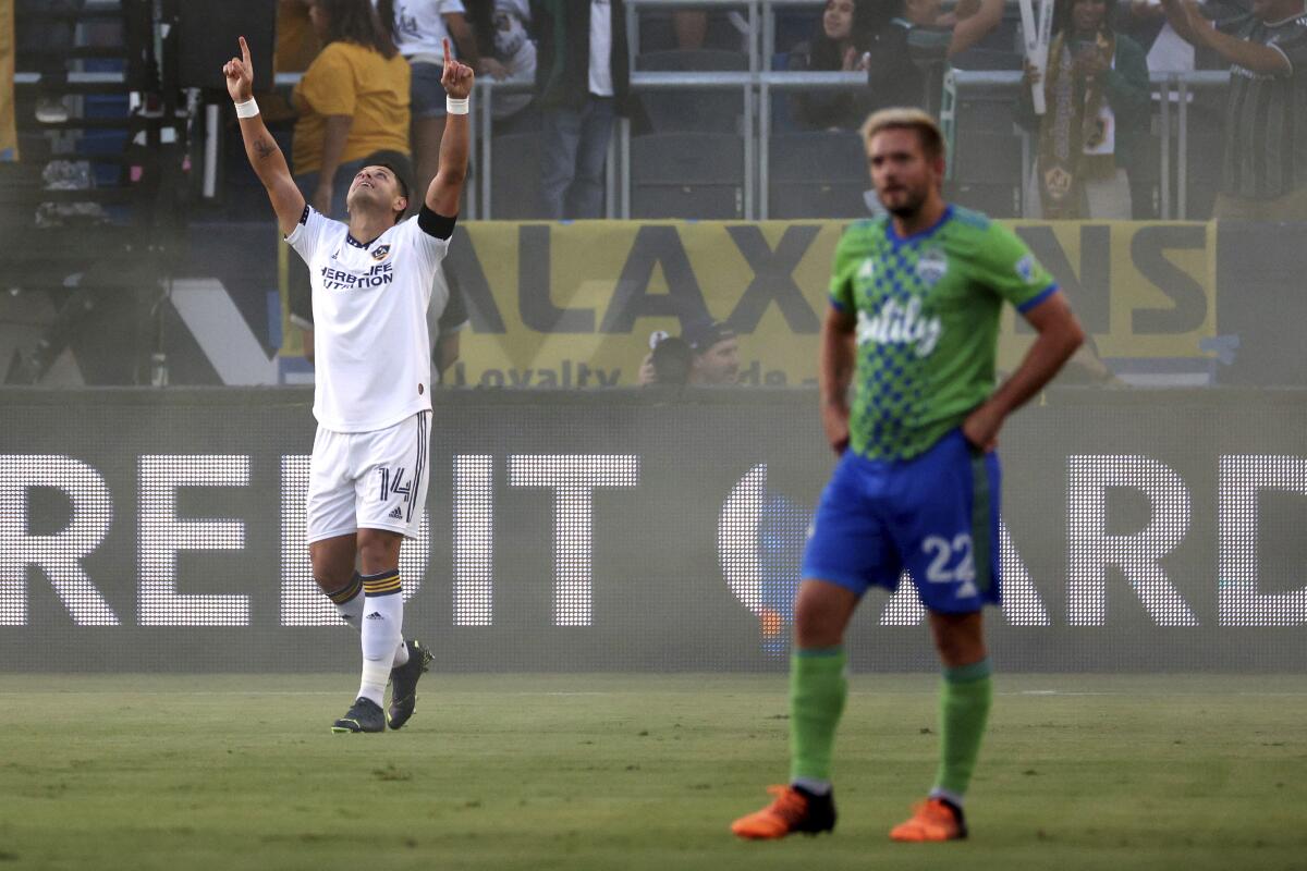 The Galaxy's Javier Hernández, left, celebrates his first-half goal against the Seattle Sounders on Aug. 19, 2022.
