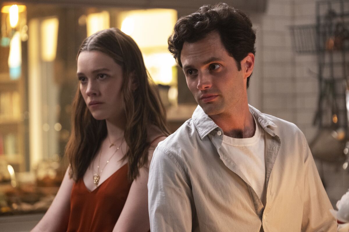 Victoria Pedretti and Penn Badgley in a scene from the Netflix series, YOU.