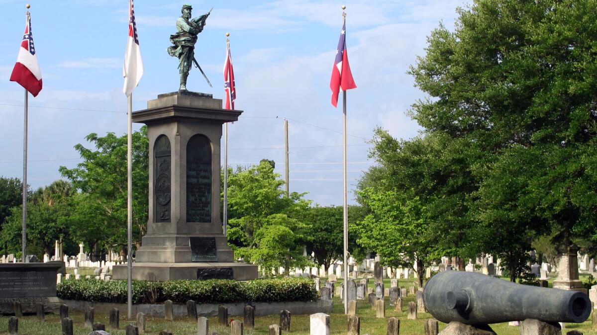 Confederate flags fly near a monument and over the graves of Confederate soldiers at Magnolia Cemetery in Charleston., S.C., on May 10, which is observed as Confederate Memorial Day in the Carolinas.