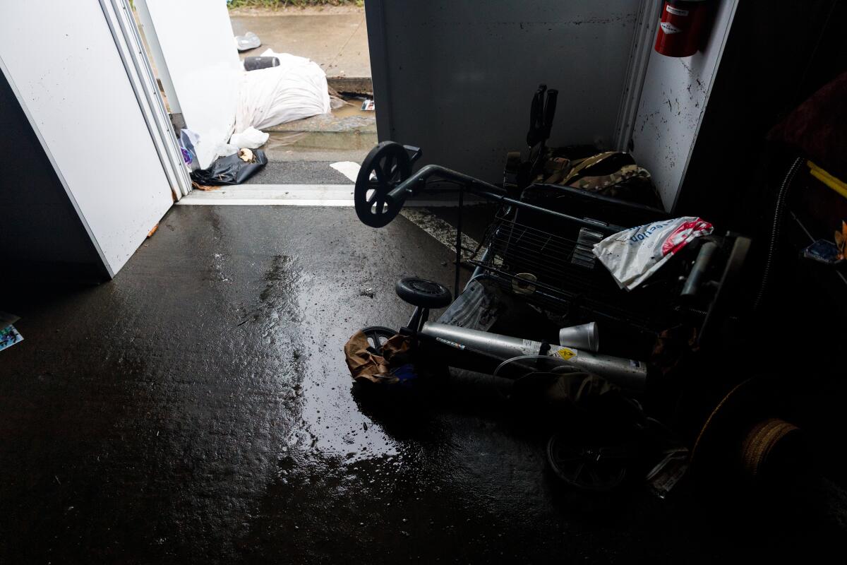 A walker lays on its side in a downtown Alpha Project tent after flooding on Jan. 22, 2024.