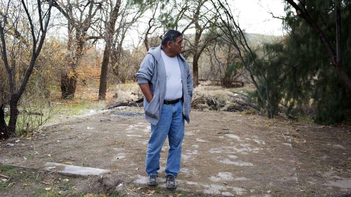 Mike Stevens stands on the foundation of the home his late wife, Lizette Stephens, lived in as a girl on the San Carlos Apache Reservation.