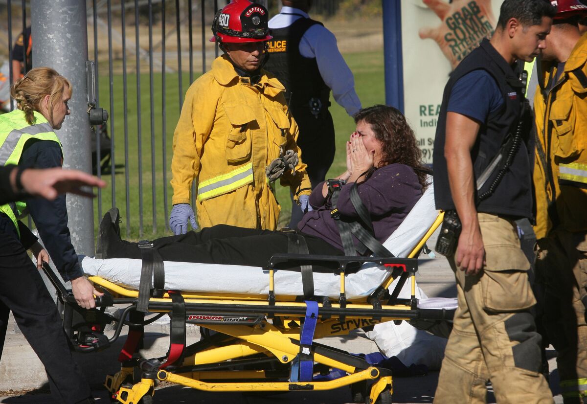 A victim is wheeled away on a stretcher following a shooting that killed multiple people at a social services facility, Wednesday, Dec. 2, 2015, in San Bernardino, Calif.