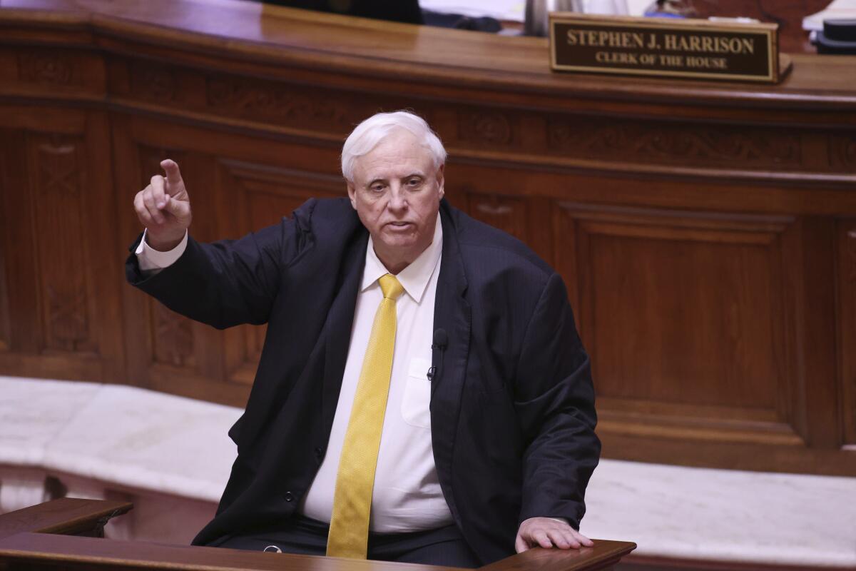 FILE - West Virginia Gov. Jim Justice speaks during the State of the State Address in the House Chambers of the West Virginia State Capitol Building in Charleston, W.Va., on Wednesday, Feb. 10, 2021. Justice has agreed to live in the seat of state government in Charleston, ending a long-running challenge over his residency. A Kanawha County judge signed an order Monday, March 1, 2021, dismissing a 2018 lawsuit filed by a former state lawmaker. (AP Photo/Chris Jackson, file)