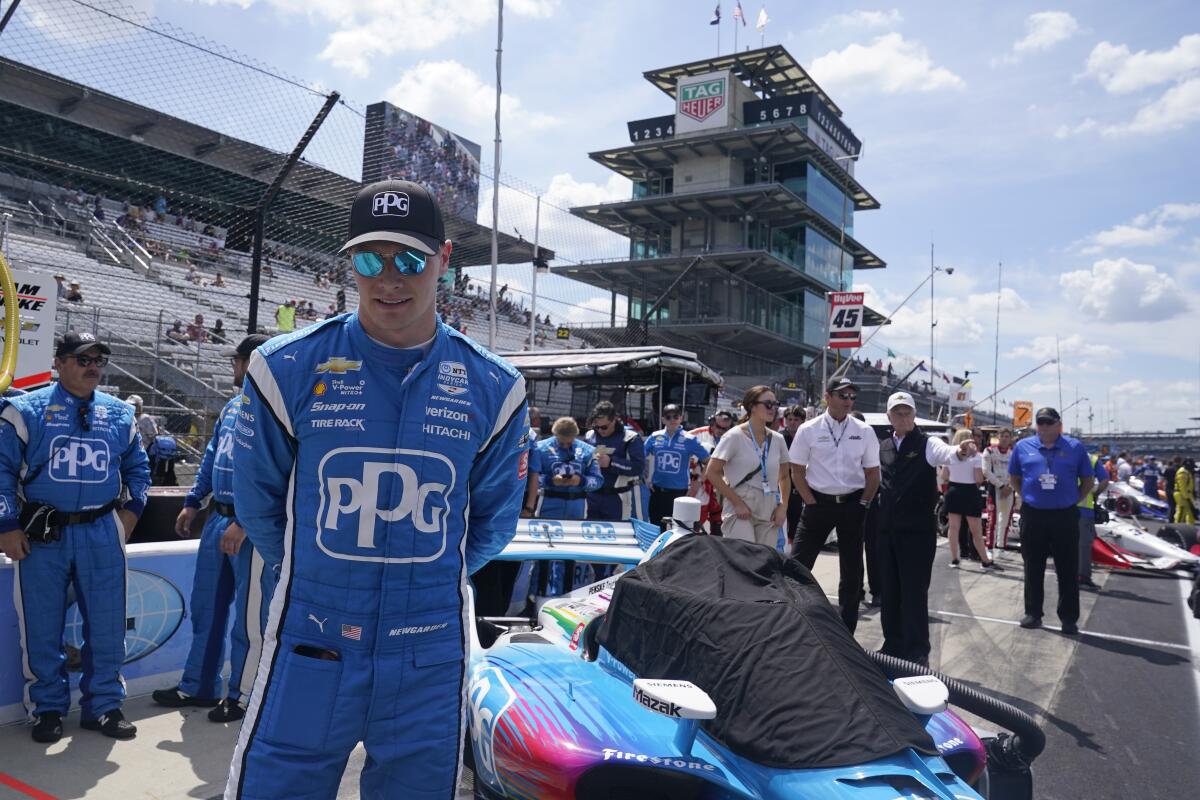 Josef Newgarden waits in the pits before a IndyCar auto race at Indianapolis Motor Speedway, Saturday, July 30, 2022, in Indianapolis. (AP Photo/Darron Cummings)