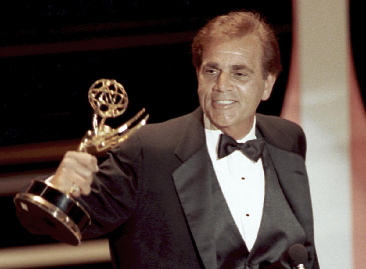 FILE - In this Sept. 16, 1990 file photo, actor Alex Rocco holds up his Emmy award for best supporting actor in a television comedy series for his role in "The Famous Teddy Z," during his acceptance speech at the 42nd Annual Primetime Emmy Awards in Pasadena, Calif. Rocco, the character actor best known for playing the bespectacled Las Vegas mobster Moe Greene in "The Godfather," has died, his daughter announced Saturday, July 18, 2015. He was 79. (AP Photo/Nick Ut, File)