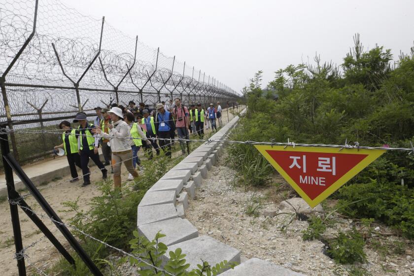 Hikers and journalists walk along the DMZ Peace Trail in the demilitarized zone in Goseong, South Korea, Friday, June 14,2019. The South Korean government opened the trails in multiple areas inside the demilitarized zone on April 27 to mark the first anniversary of the first inter-Korean summit between South Koran President Moon Jae-in and North Korean leader Kim Jong Un. (AP Photo/Ahn Young-joon)