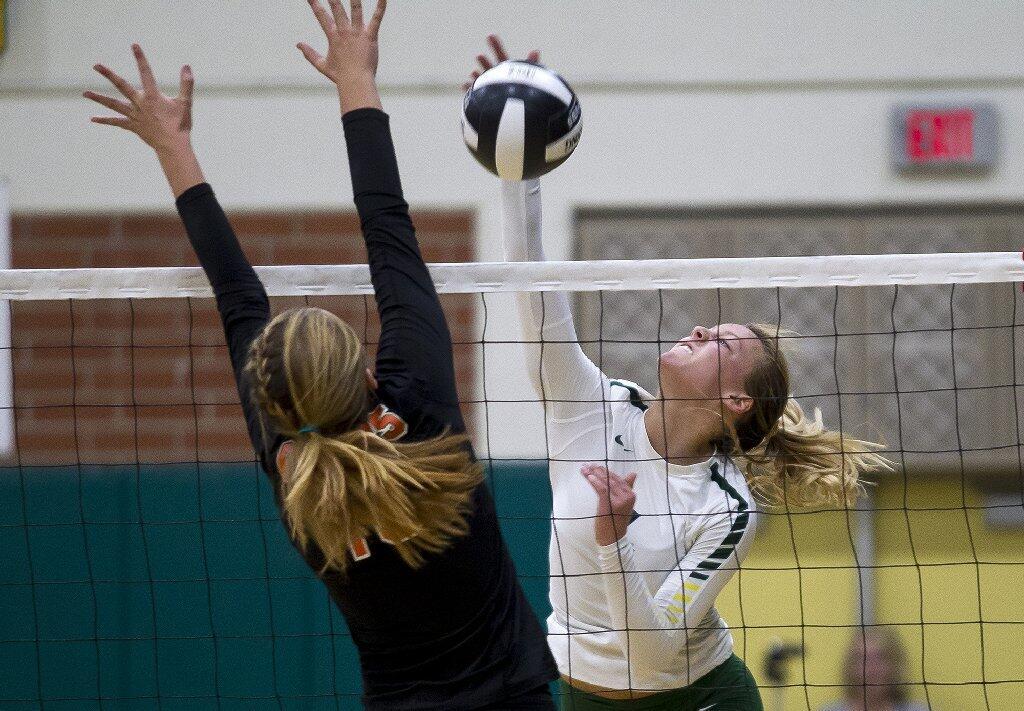 Edison's Hannah Phair hits into Huntington Beach's Cami Sanchez.