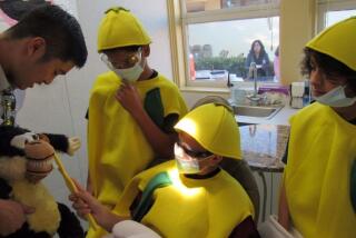 In 2017, then-Lemon Grove Academy eighth graders (left to right) Efrain Duarte, Emillio Cecena and Sam Oser got a lesson in dental health from Clinic Manager Jonathan Wong. UCSD School of Medicine’s doctors and volunteers treat students and their families at no cost at the on-campus clinic.