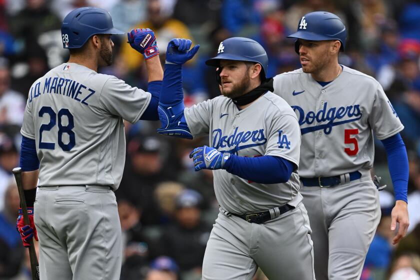 CHICAGO, IL - APRIL 23: Max Muncy #13 of the Los Angeles Dodgers is congratulated by J.D. Martinez.