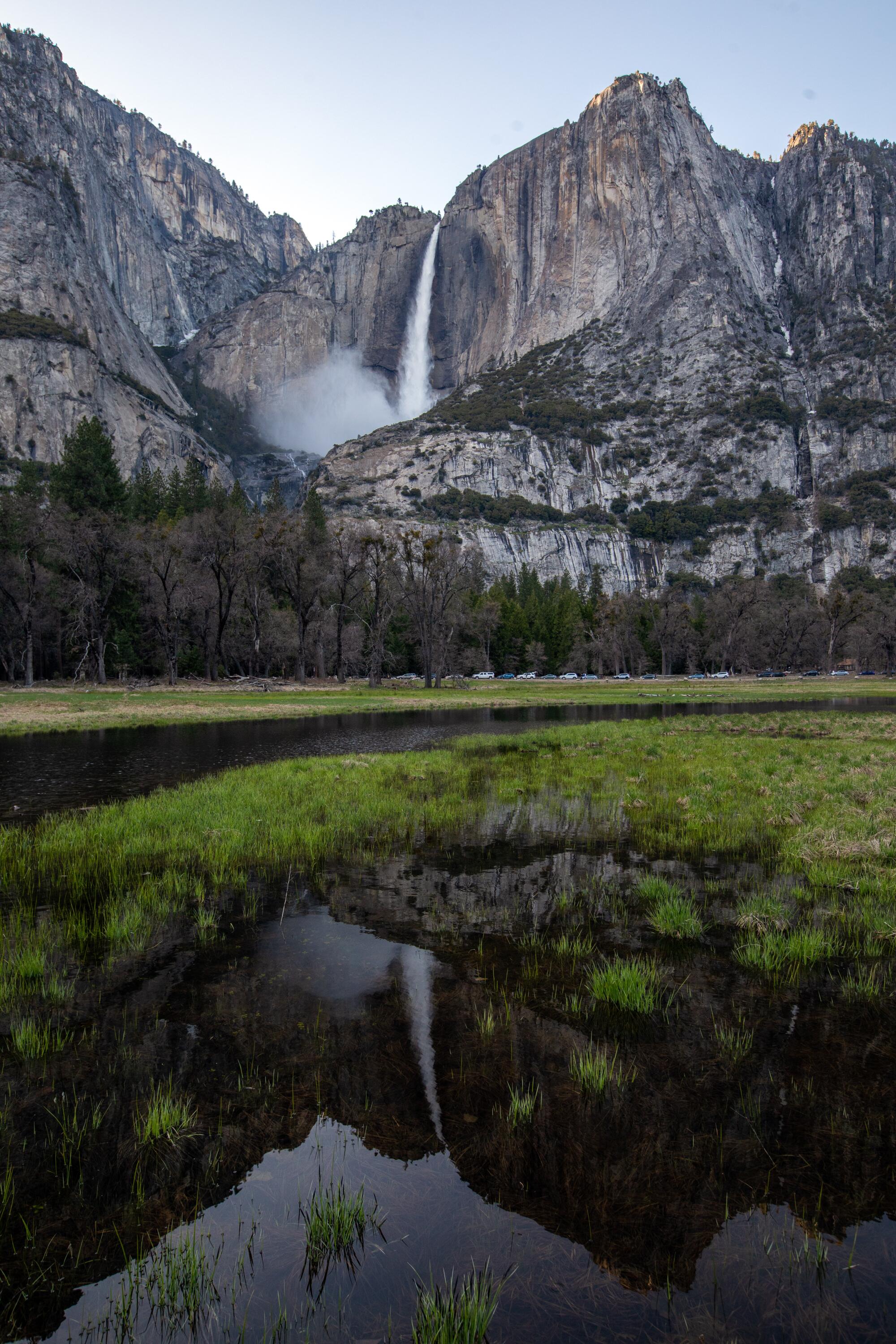 A waterfall is reflected in water in the meadow in the Yosemite Valley.