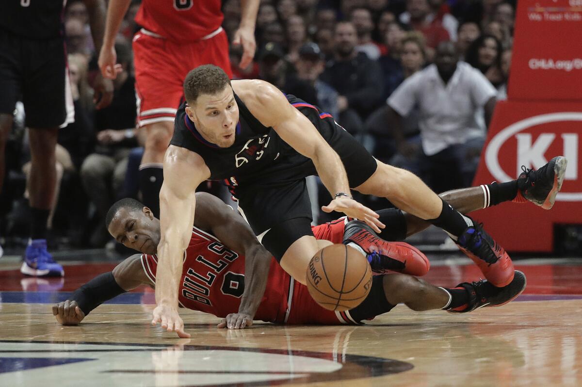 Clippers forward Blake Griffin is tripped by Bulls point guard Rajon Rondo during the first half.
