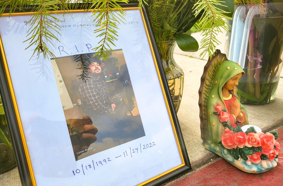 Flowers, candles and a photo mark where Lucas Rivera-Velasco was shot and killed in Costa Mesa on Thanksgiving.