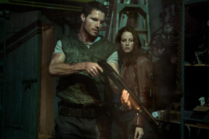 Robbie Amell and Kaya Scodelario in “Resident Evil: Welcome to Raccoon City.”