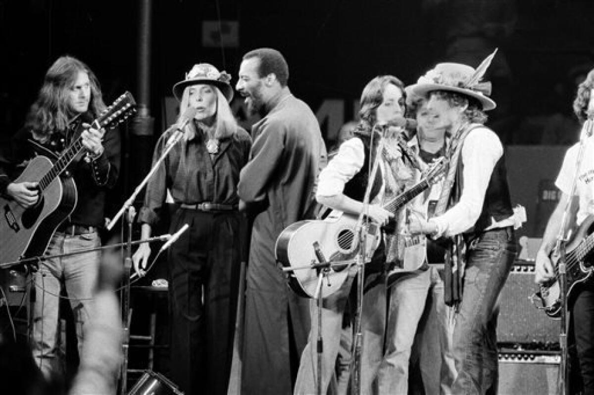 In this Dec. 1975 file photo, musicians Roger McGuinn, Joni Mitchell, Richie Havens, Joan Baez and Bob Dylan perform the finale of the The Rolling Thunder Revue, a tour headed by Dylan. McGuinn, the former leader of The Byrds, says his new concert tour with Marty Stuart and The Fabulous Superlatives will have a free-flowing format "pretty similar to to 'The Rolling Thunder Revue'." (AP Photo, File)