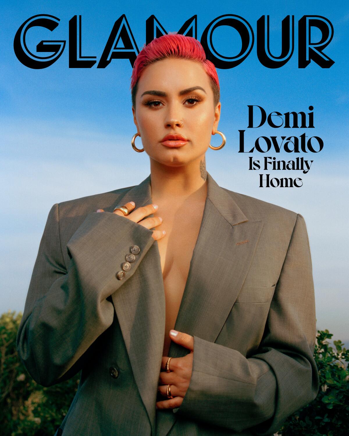Demi Lovato in a suit jacket with no shirt on the March cover of Glamour