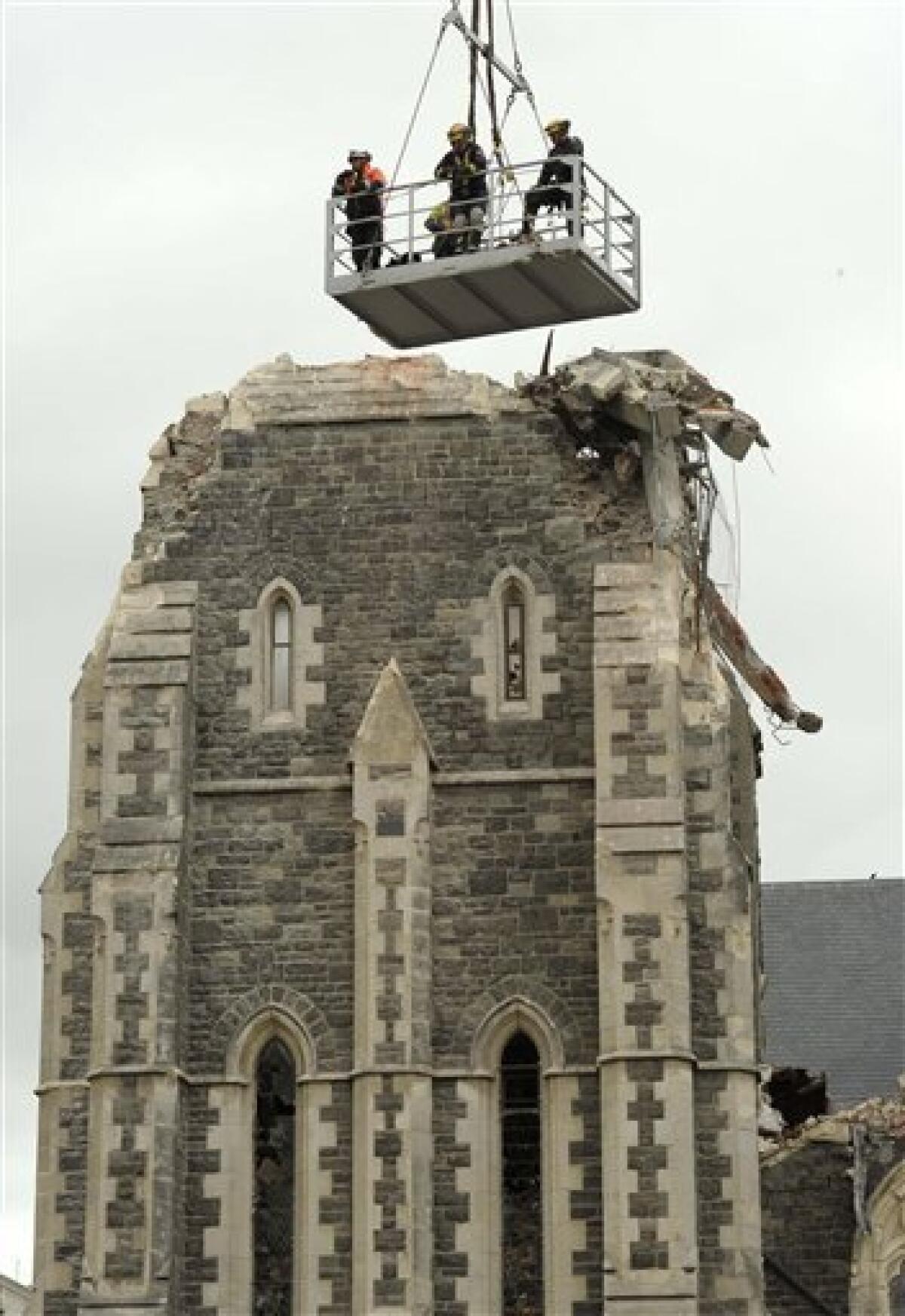 Recovery operation workers are lowered by crane onto the top of the Christchurch Cathedral in Christchurch, New Zealand, Friday, Feb. 25, 2011. A magnitude 6.3 quake struck Christchurch near lunchtime on Tuesday, collapsing buildings and causing massive damage in one of the country's worst natural disasters. (AP Photo/Rob Griffith)