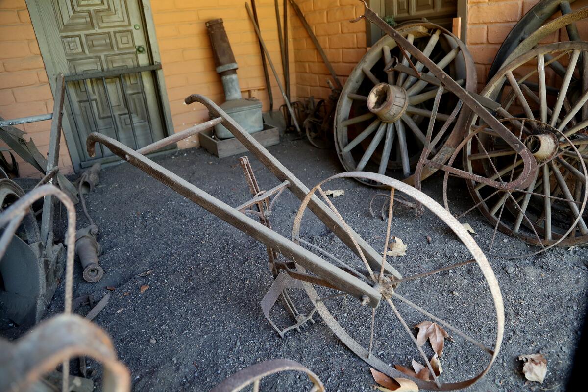 Vintage wheels from a farming vehicle are stored in the alcove at the Diego Sepulveda Adobe at Estancia Park in Costa Mesa.