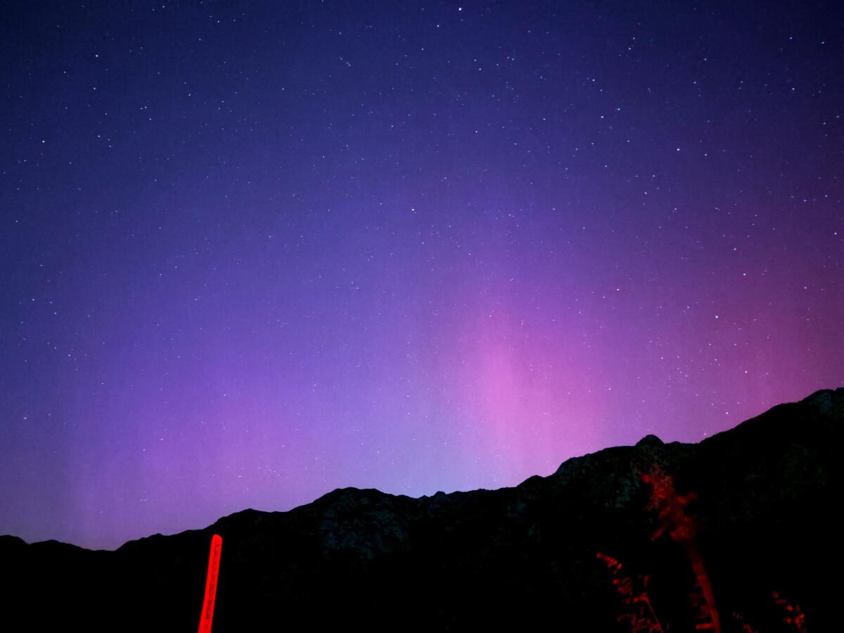 Purple northern lights above a ridge in Angeles National Forest.