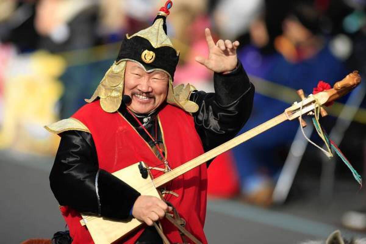 Kongar-ol Ondar waves to the crowd along Colorado Boulevard in Pasadena during the Rose Parade in 2013.