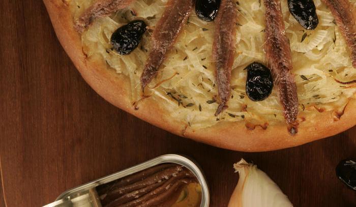Pissaladiere is like a French pizza with caramelized onions, anchovies and black olives.