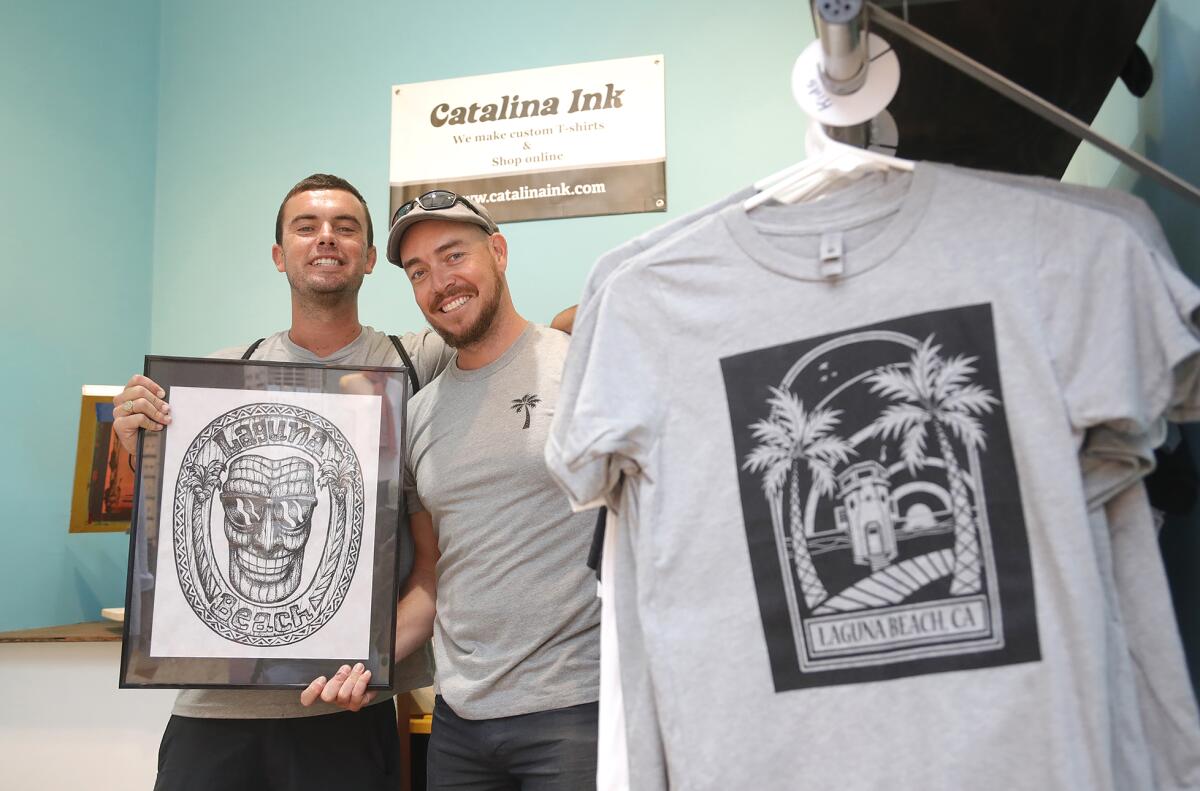 Silk screen artists Chris Kennedy and Bradford Smith, from left, of Catalina Ink, on opening day of the Sawdust Festival.