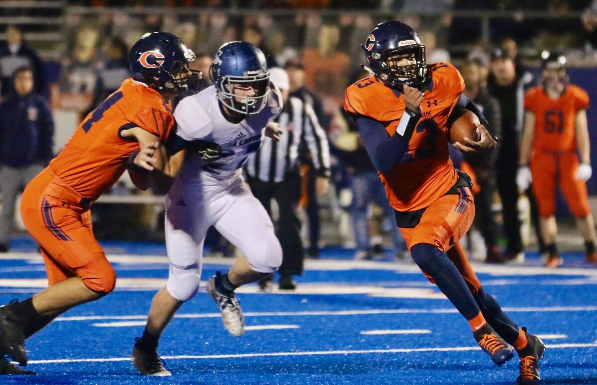 Chaminade quarterback Jaylen Henderson escapes from the pocket in Friday’s Southern Section Division 2 final in West Hills. Sierra Canyon defeated Chaminade, 35-7.