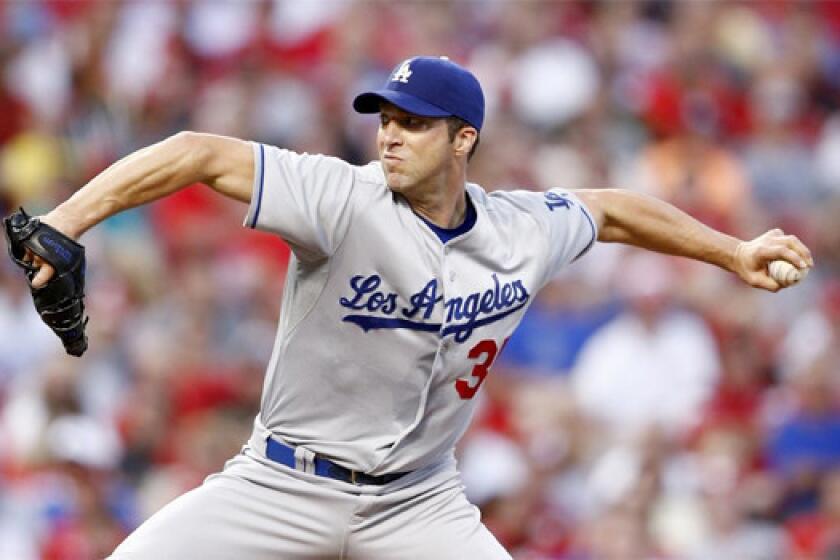 Left-hander Chris Capuano looked sharp pitching for the first time since Sept. 6 in the Dodgers' 11-0 victory over the Colorado Rockies on Friday.