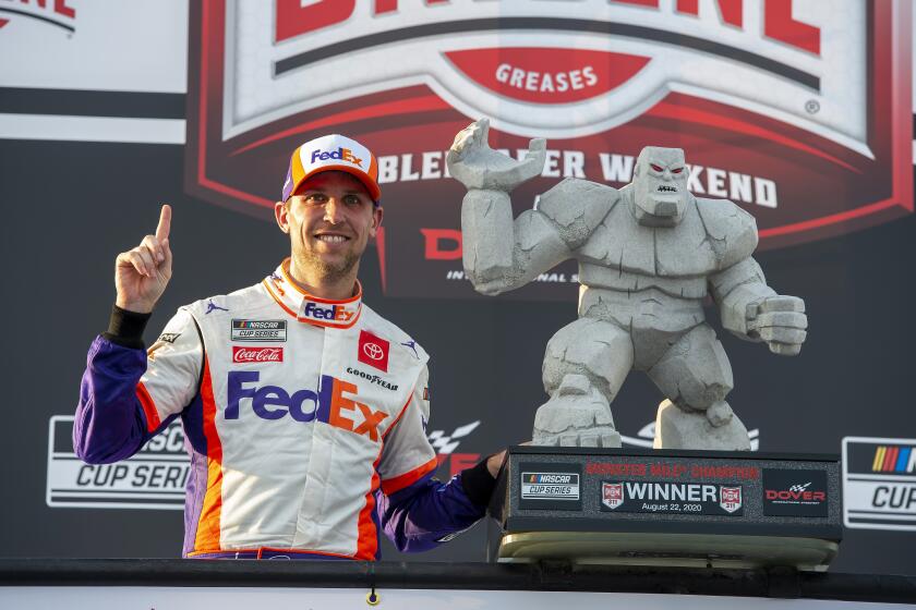 Denny Hamlin celebrates after winning the NASCAR Cup Series race at Dover International Speedway on Aug. 22, 2020.