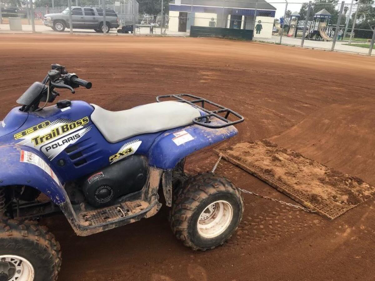 An ATV on a baseball diamond.