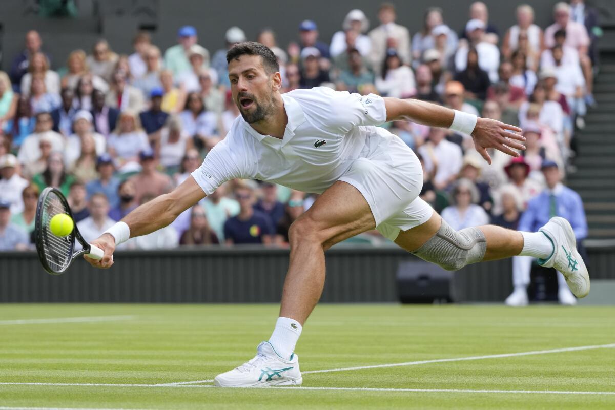 Novak Djokovic plays a forehand return against Jacob Fearnley during their second-round match.