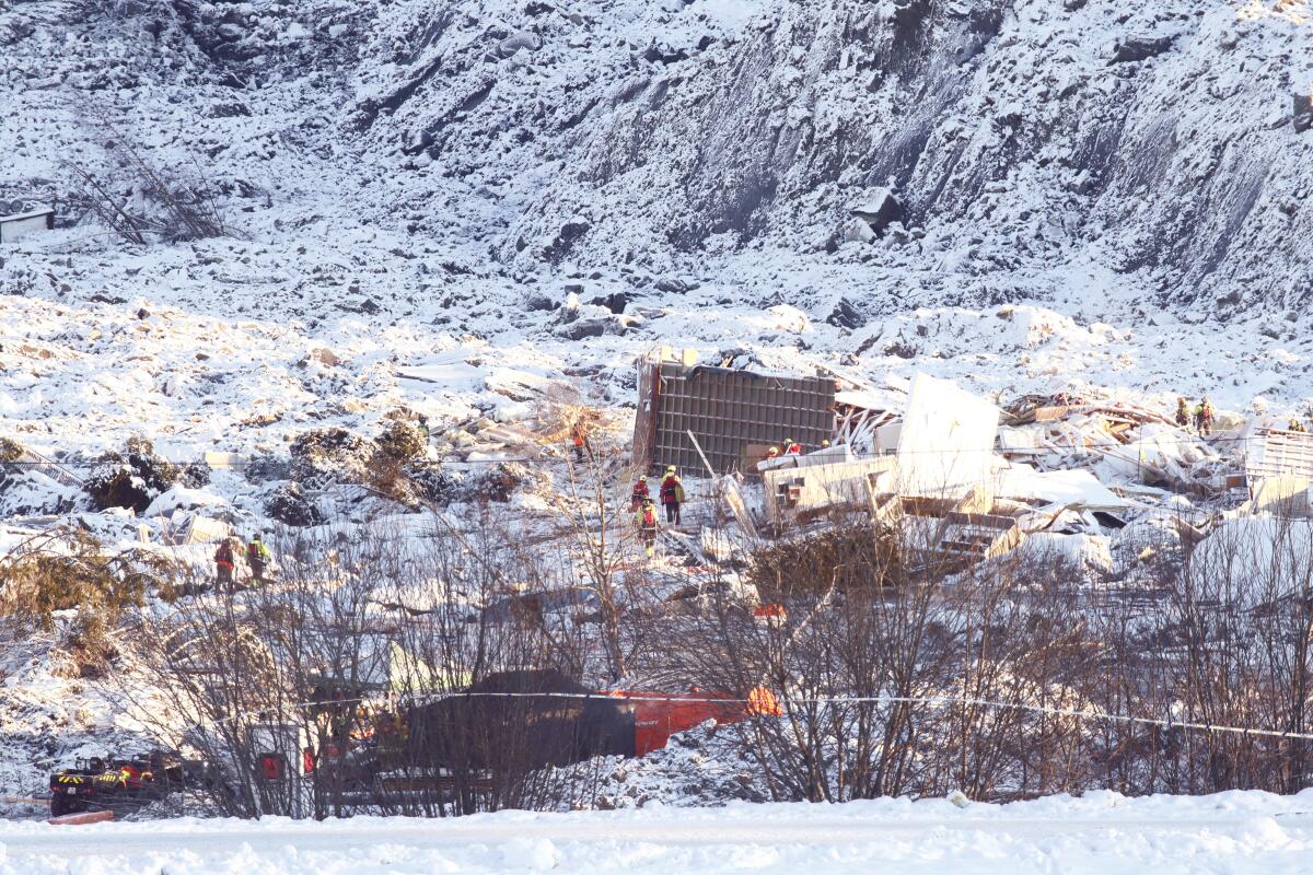 Rescue workers continue their efforts at the site of a major landslide in Ask, Norway, on Monday.