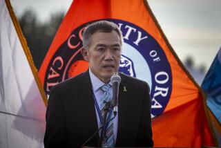 Anaheim, CA - January 13: Orange County public health director, Dr. Clayton Chau speaks at a news conference as Orange County active Phase 1A (critical and healthcare workers) residents exit large tents at Orange County's first large-scale vaccination site after receiving the Moderna COVID-19 vaccine in the Toy Story parking lot at the Disneyland Resort in Anaheim Wednesday, Jan. 13, 2021. Orange County supervisors and Orange County Health Care Agency Director Dr. Clayton Chau held a news conference discussing the county's first Super POD (point-of-dispensing) site for COVID-19 vaccine distribution. The vaccinations are at Tier 1A for people who have reservations on a website. The site is able to handle 7,000 immunizations per day. Their goal is to immunize everyone in Orange County who chooses to do so by July 4th. (Allen J. Schaben / Los Angeles Times)