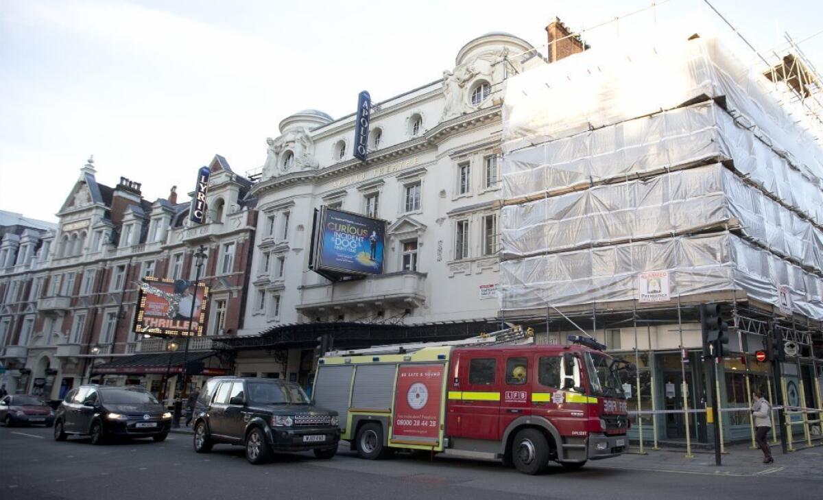 A fire brigade truck waits outside the Apollo Theatre in London on Friday following a partial structural collapse during a Thursday evening performance of the play "The Curious Incident of the Dog in the Night-Time."