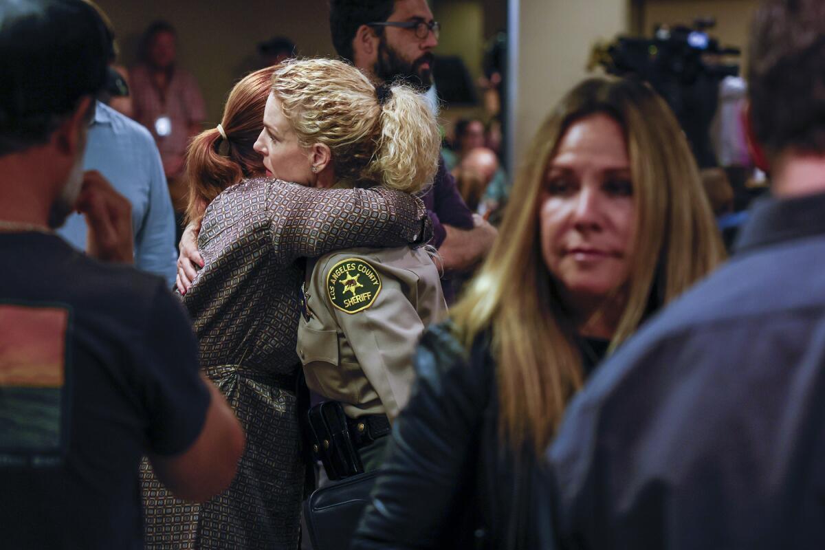 L.A. County Supervisor Lindsey Horvath, left, hugs L.A. County sheriff's Capt. Jennifer Seetoo