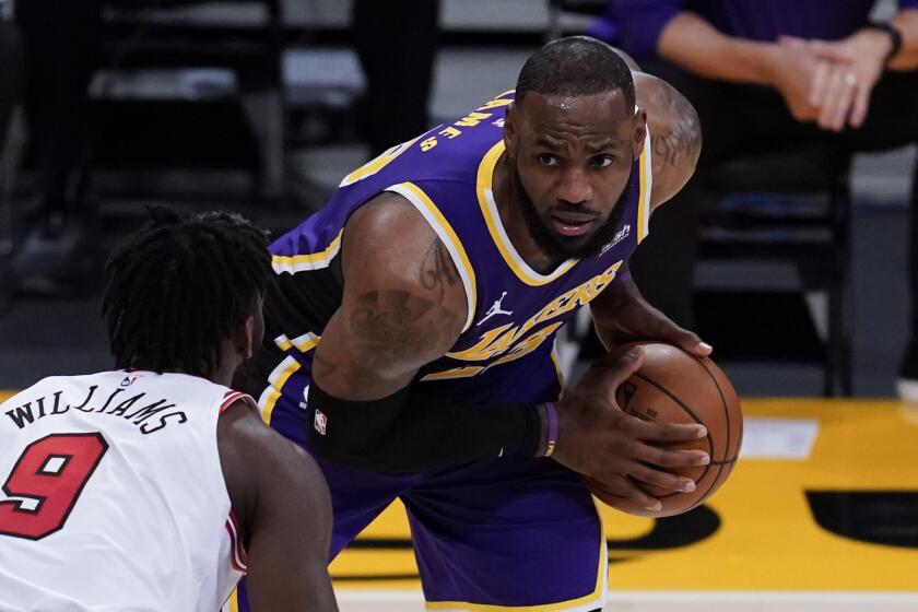 Los Angeles Lakers forward LeBron James, right, looks past Chicago Bulls forward Patrick Williams.