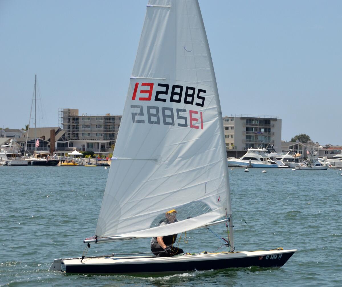 Orange Coast College sailing instructor Brad Gilreath competes in Flight of Newport Sunday on his Laser sailboat.