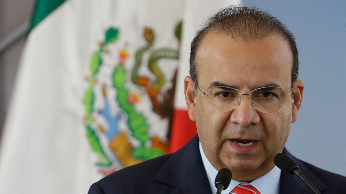 Mexico's Interior Secretary Alfonso Navarrete, shown on Tuesday, has said the federal intelligence agency sent a plainclothes agent to tail an opposition presidential candidate.