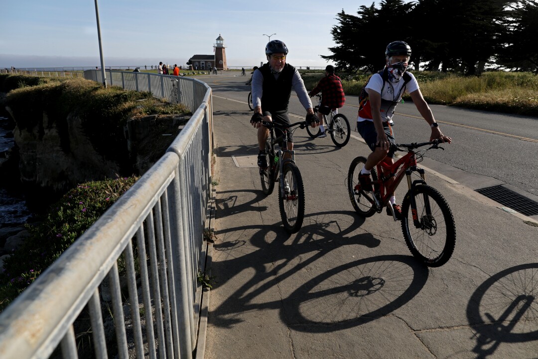 Bicyclists ride along West Cliff Drive in Santa Cruz.