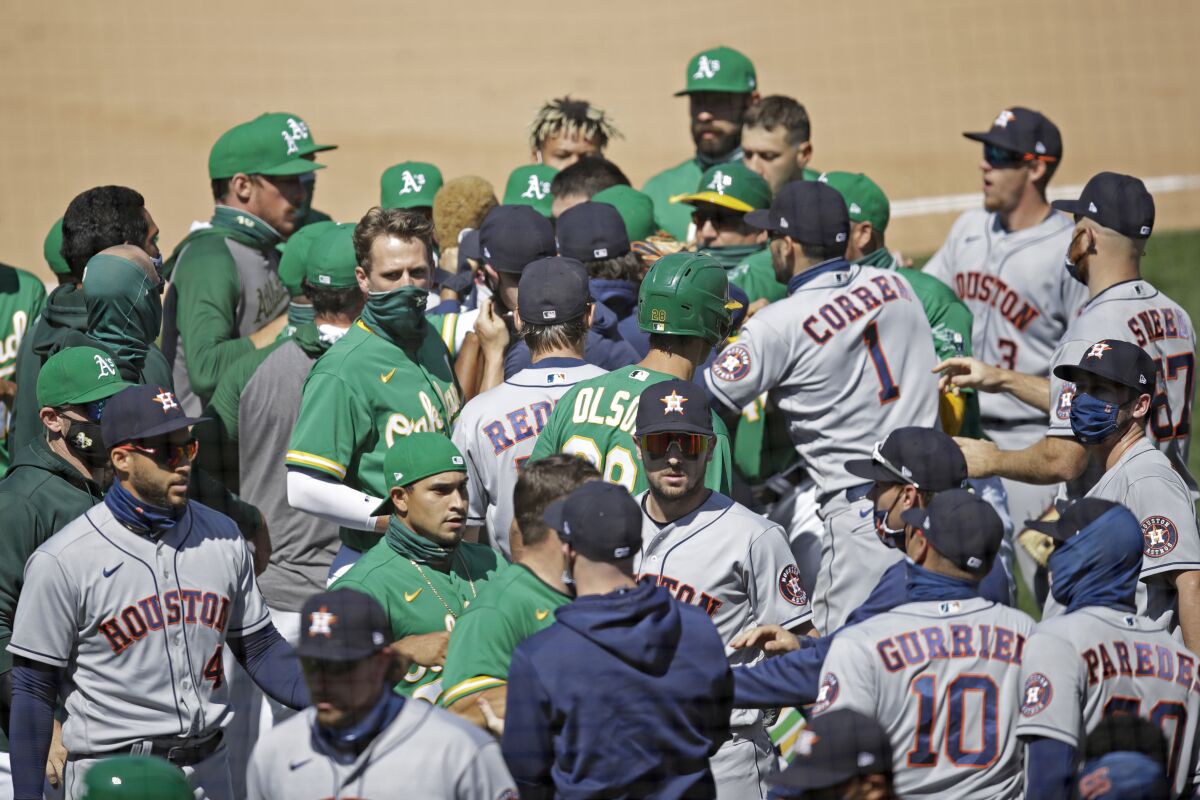 Oakland Athletics and Texas Rangers scuffle after Athletics' Ramon Laureano charged the dugout after being hit by a pitch thrown by Astros' Humberto Castellanos during the seventh inning of a baseball game Sunday, Aug. 9, 2020, in Oakland, Calif. (AP Photo/Ben Margot)