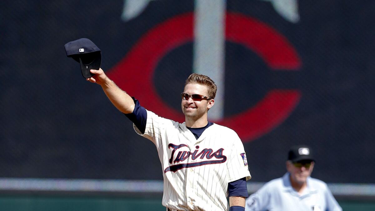 Minnesota Twins second baseman Brian Dozier acknowledges the standing ovation by fans after it was announced during the baseball game against the Detroit Tigers that he was named to the American League All-Star team.