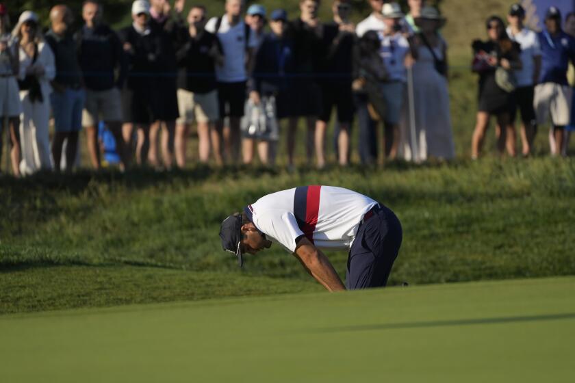 United States' Scottie Scheffler reacts after a poor shot on the 3rd green during their morning Foursomes match at the Ryder Cup golf tournament at the Marco Simone Golf Club in Guidonia Montecelio, Italy, Saturday, Sept. 30, 2023. (AP Photo/Gregorio Borgia )