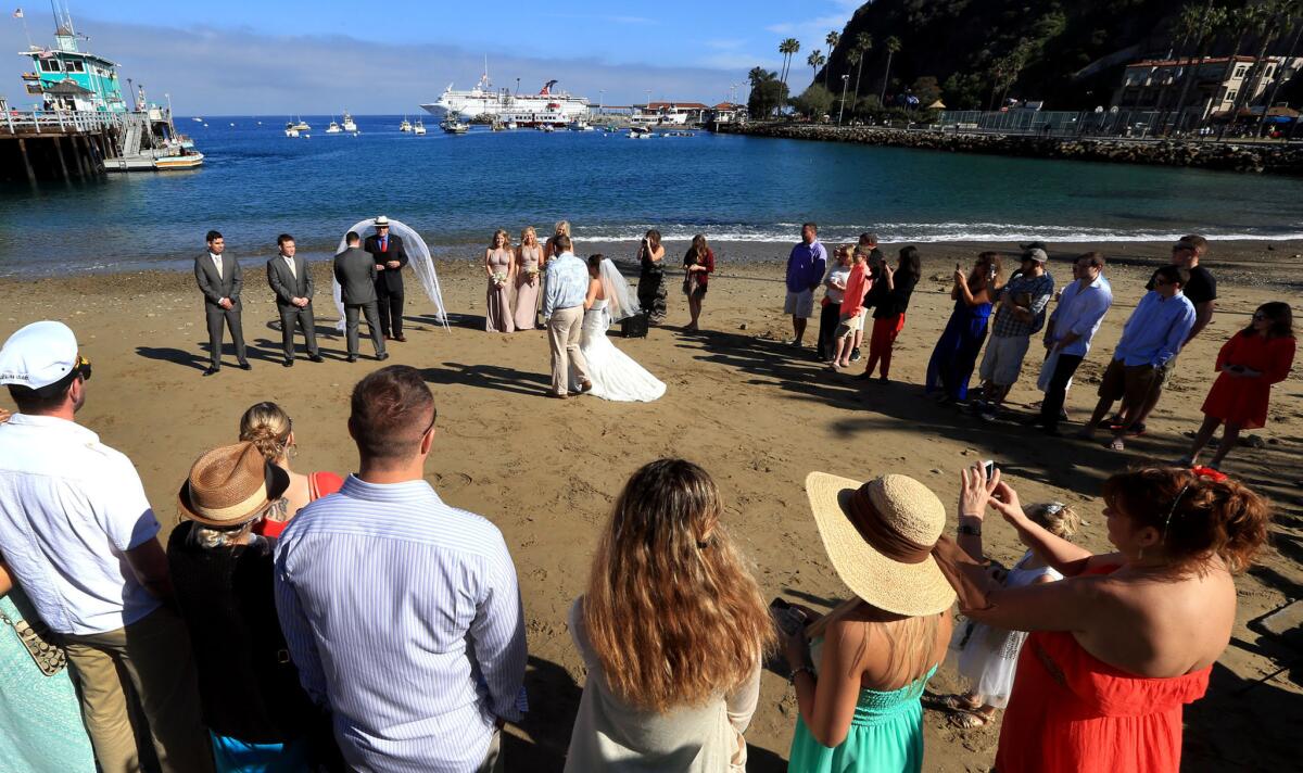 A wedding is underway on the beach fronting Avalon Bay on Santa Catalina Island.
