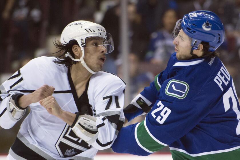 Kings center Jordan Nolan fights with Canucks defenseman Andrey Pedan during a Dec. 28 game in Vancouver, Canada.